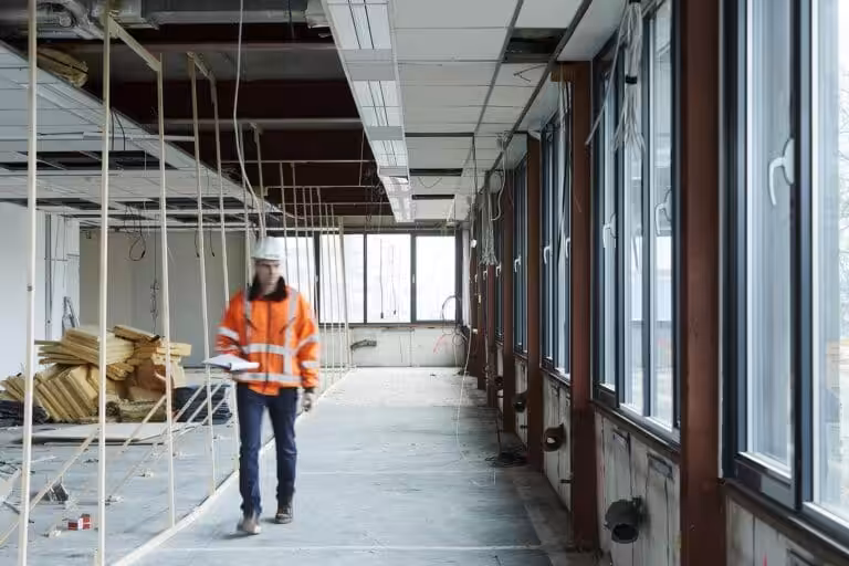Construction site with worker inspecting area.